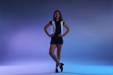 Photo of Teenage girl in tap shoes on color background