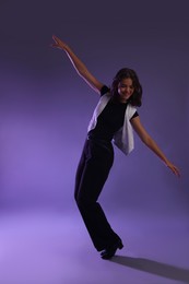 Photo of Teenage girl in tap shoes dancing on color background