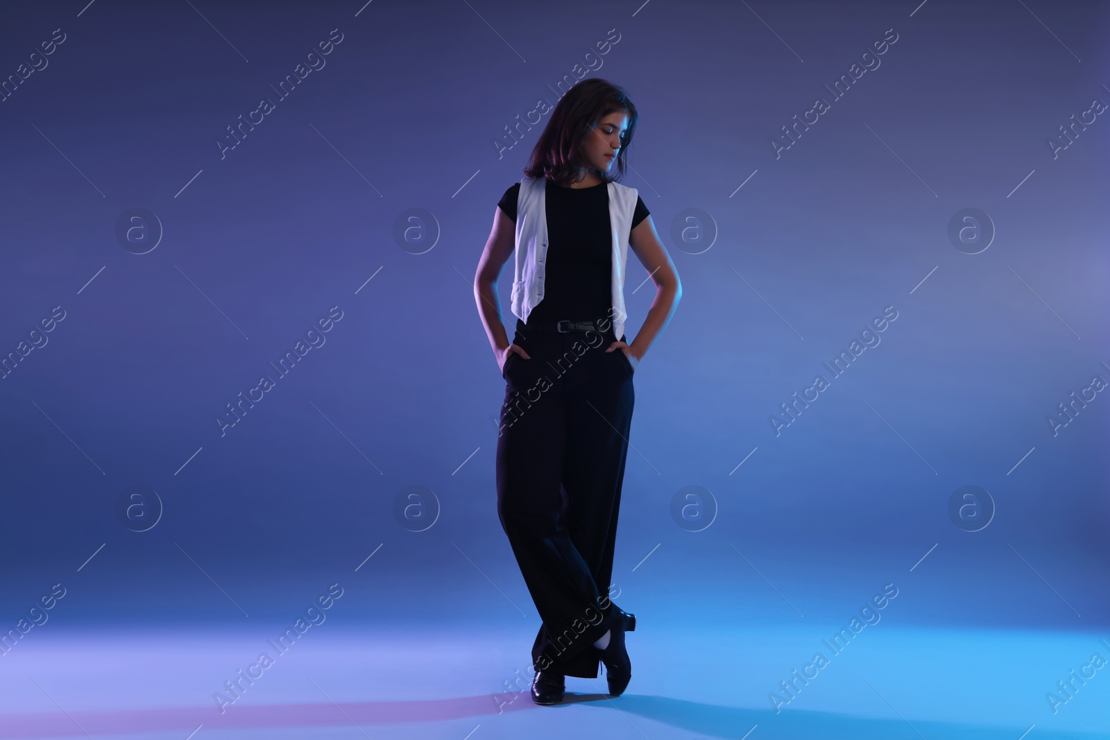 Teenage girl in tap shoes on color background Photo of Teenage girl in tap shoes on color background