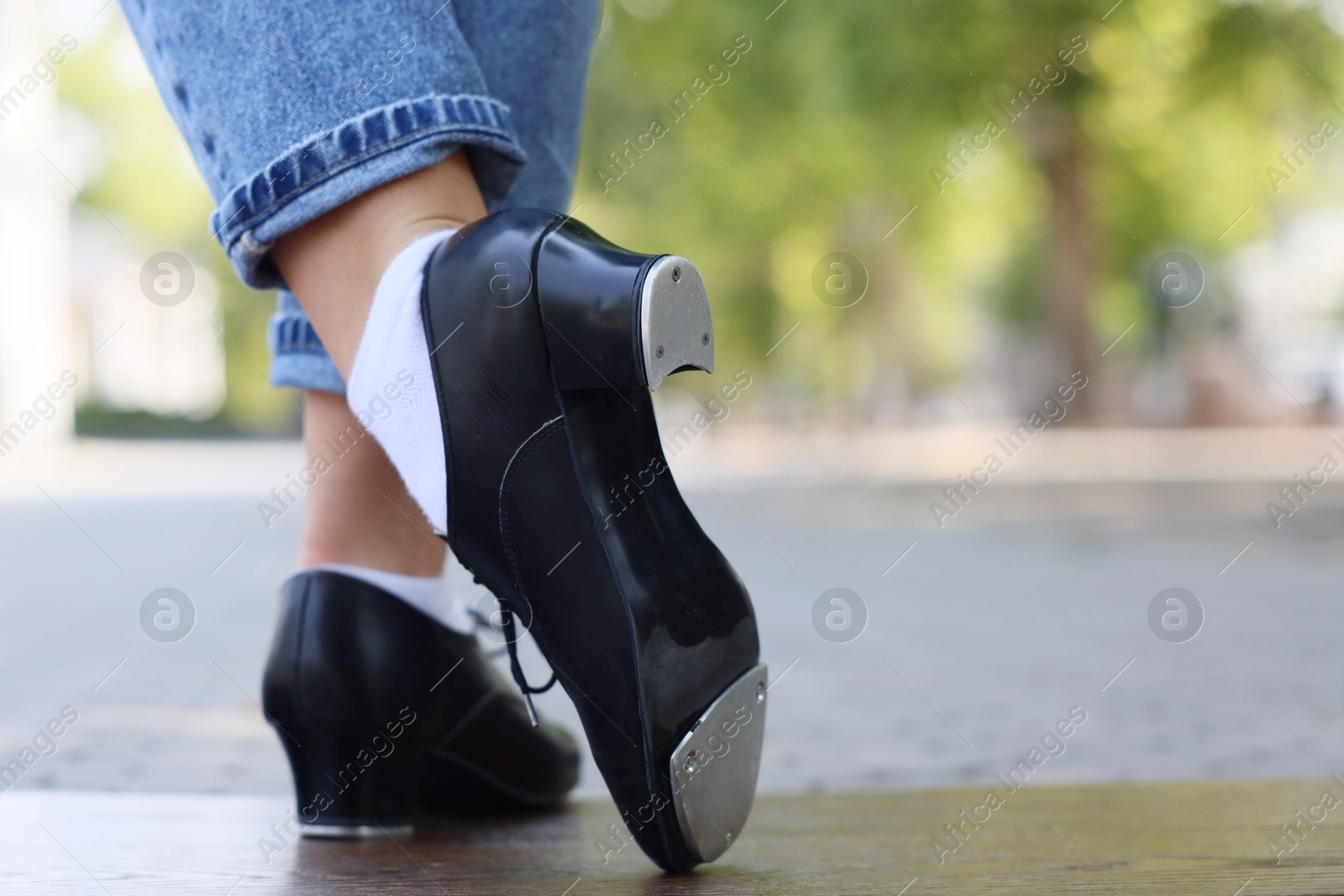 Teenage girl in tap shoes dancing outdoors, closeup Photo of Teenage girl in tap shoes dancing outdoors, closeup