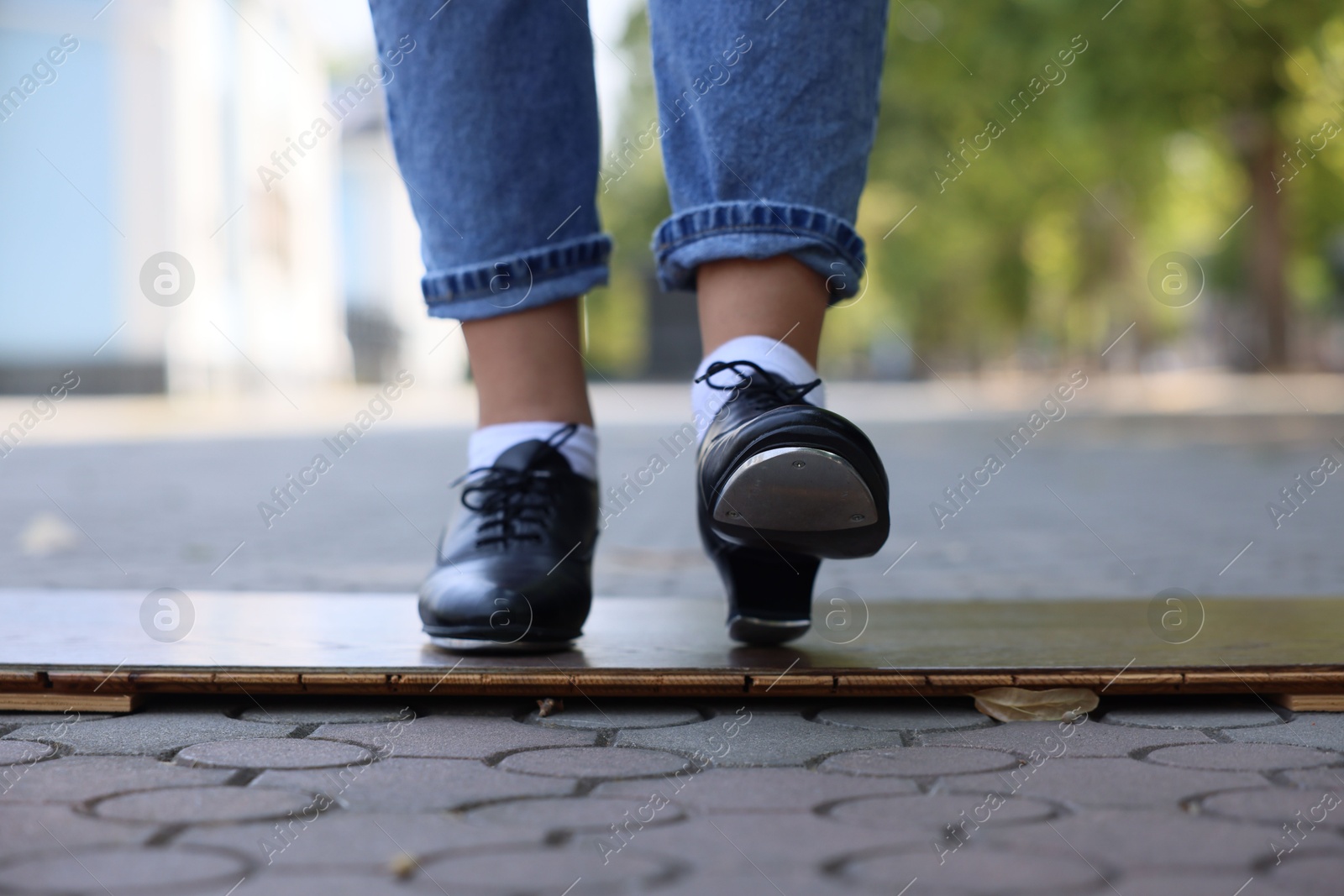 Teenage girl in tap shoes dancing outdoors, closeup Photo of Teenage girl in tap shoes dancing outdoors, closeup