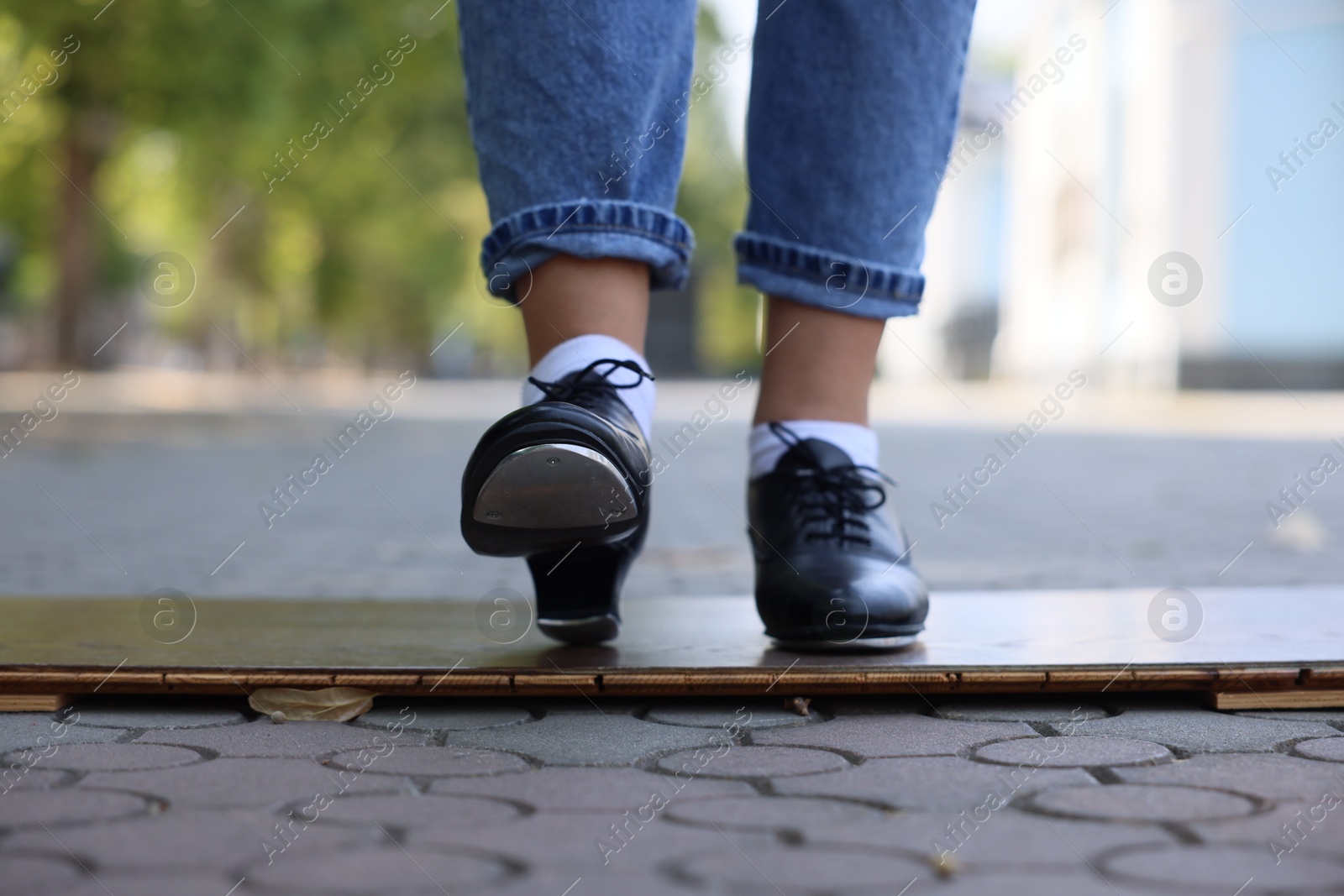Teenage girl in tap shoes dancing outdoors, closeup Photo of Teenage girl in tap shoes dancing outdoors, closeup