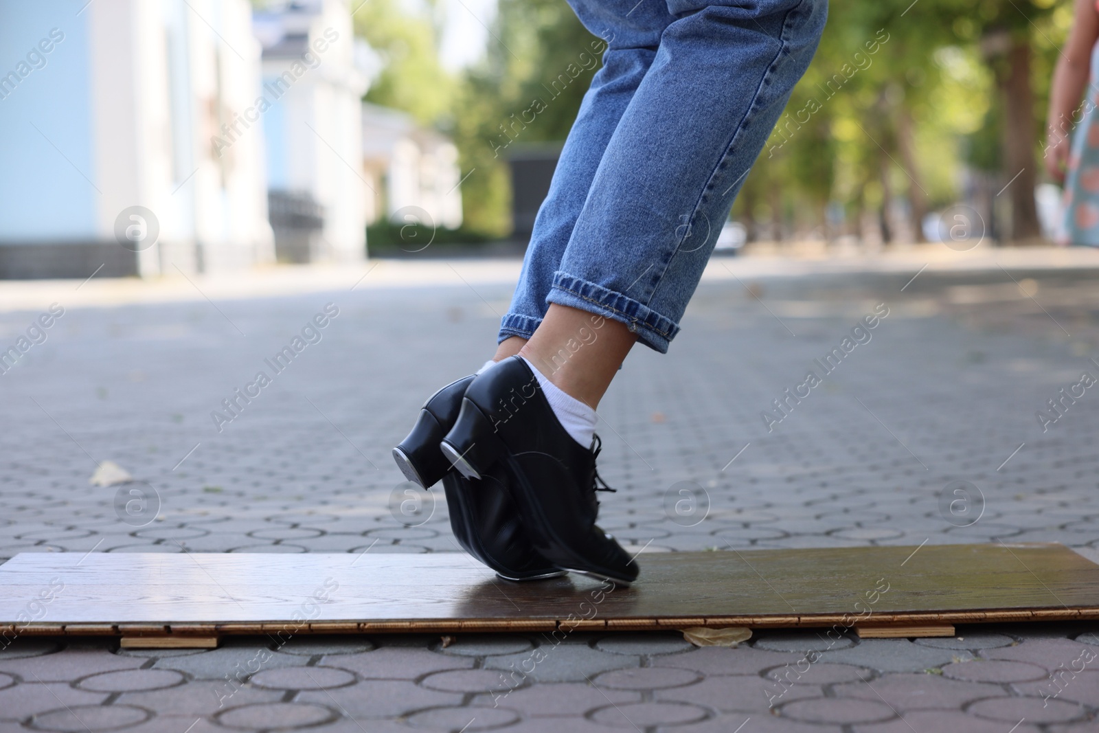 Teenage girl in tap shoes dancing outdoors, closeup Photo of Teenage girl in tap shoes dancing outdoors, closeup