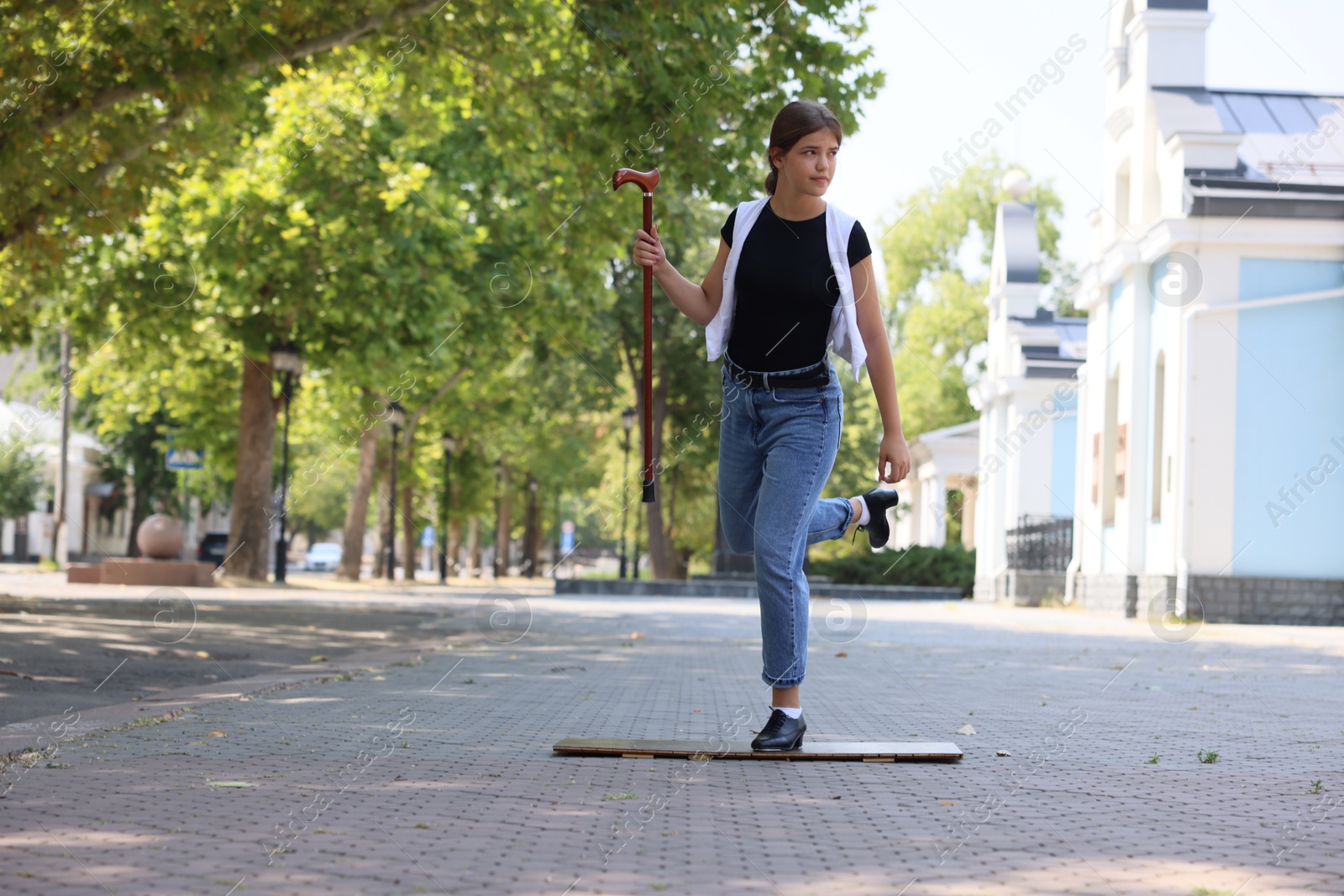 Teenage girl in tap shoes dancing outdoors Photo of Teenage girl in tap shoes dancing outdoors