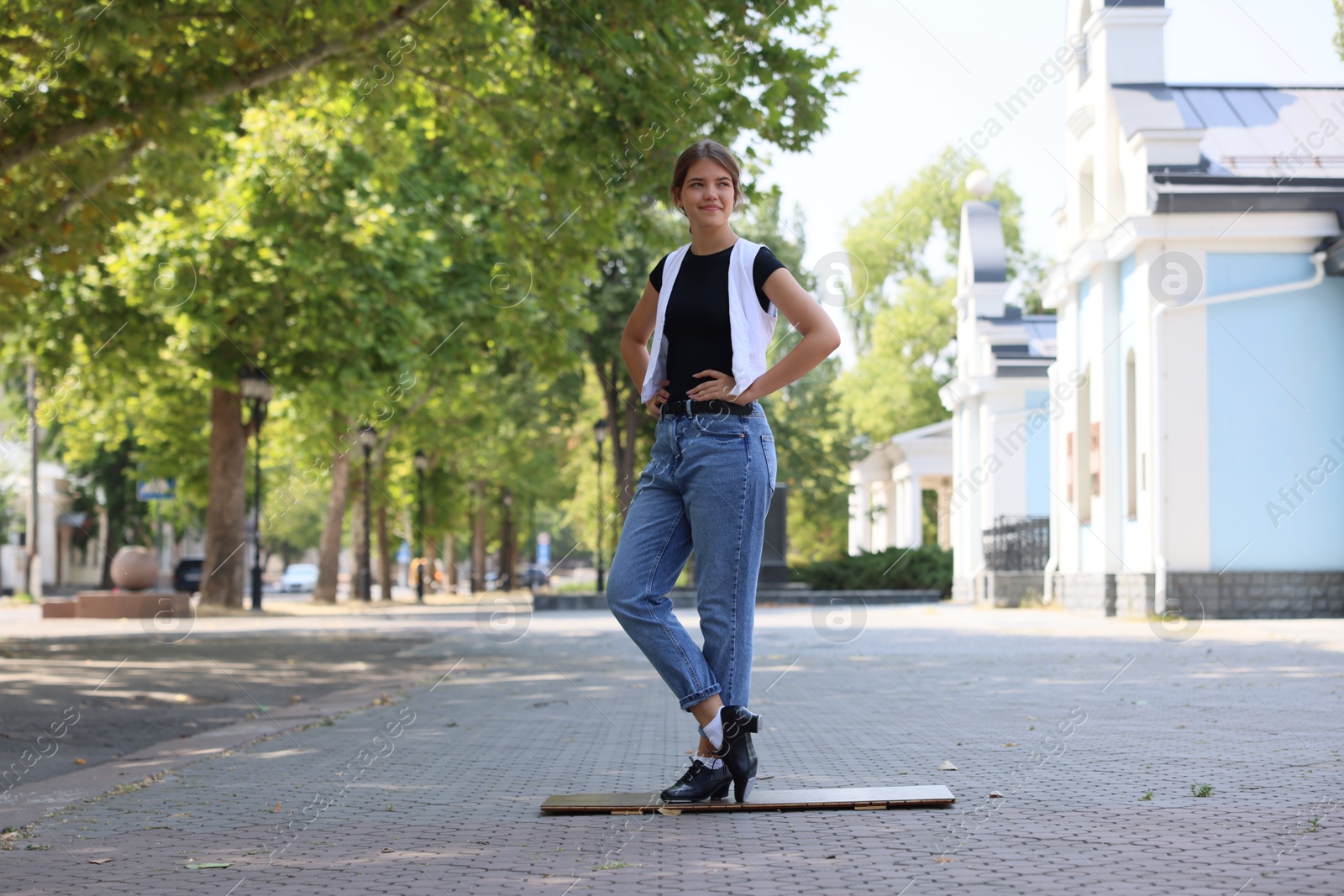 Teenage girl in tap shoes dancing outdoors Photo of Teenage girl in tap shoes dancing outdoors