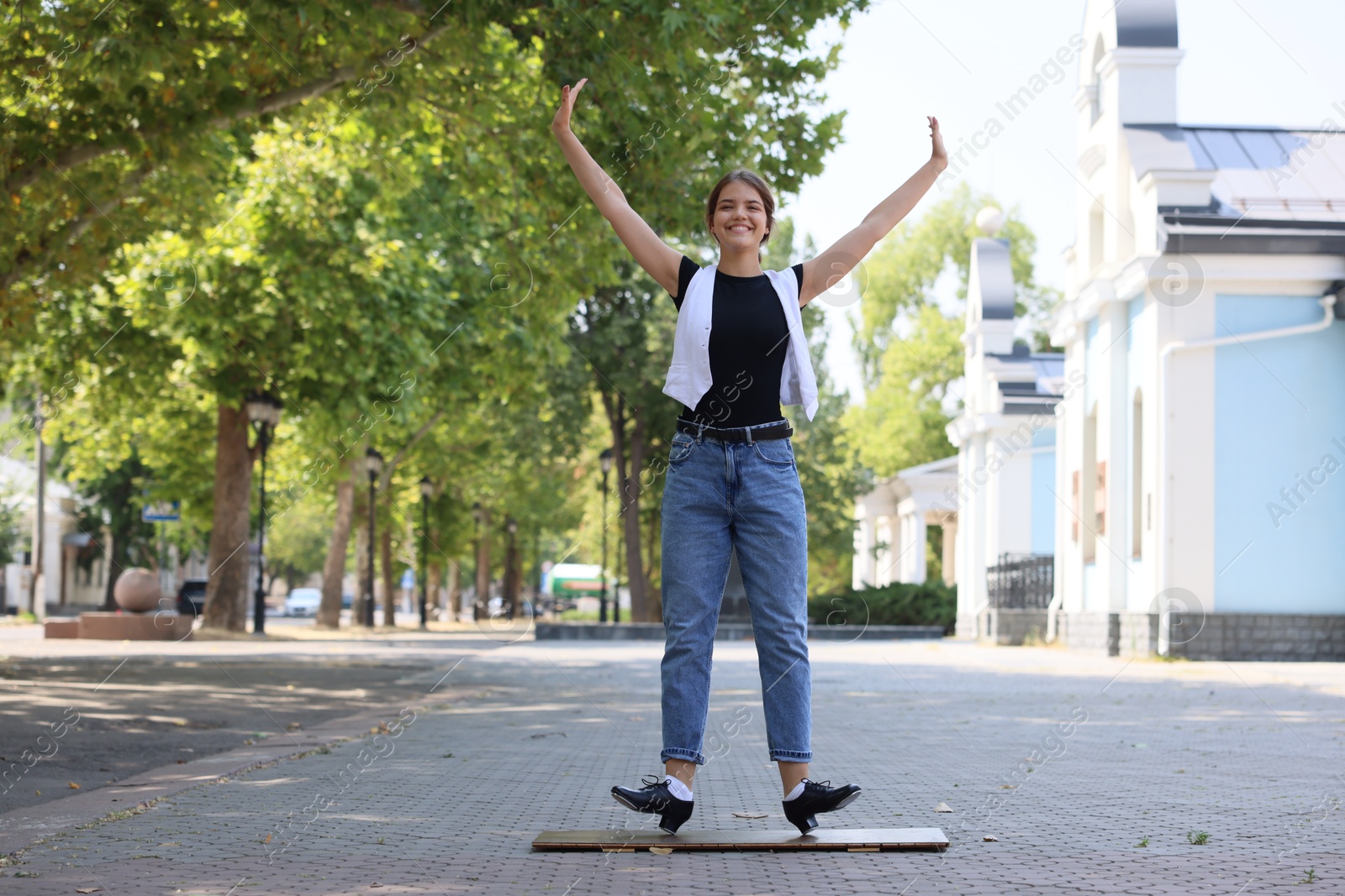Teenage girl in tap shoes dancing outdoors Photo of Teenage girl in tap shoes dancing outdoors