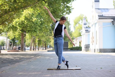 Photo of Teenage girl in tap shoes dancing outdoors