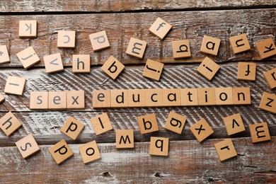 Photo of Phrase Sex Education made with wooden letters on table, flat lay