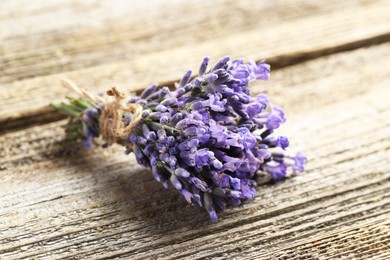Photo of Bunch of beautiful lavender flowers on wooden table, closeup