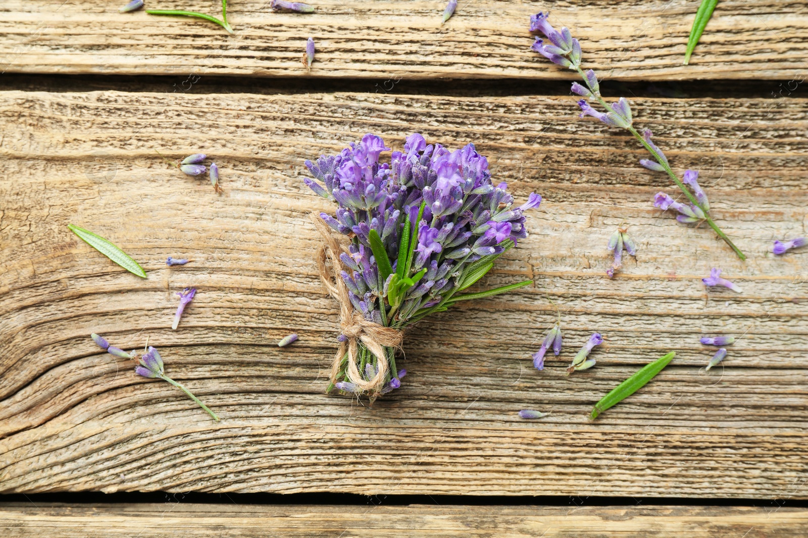 Photo of Bunch of beautiful lavender flowers on wooden table, flat lay