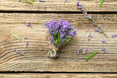 Photo of Bunch of beautiful lavender flowers on wooden table, flat lay