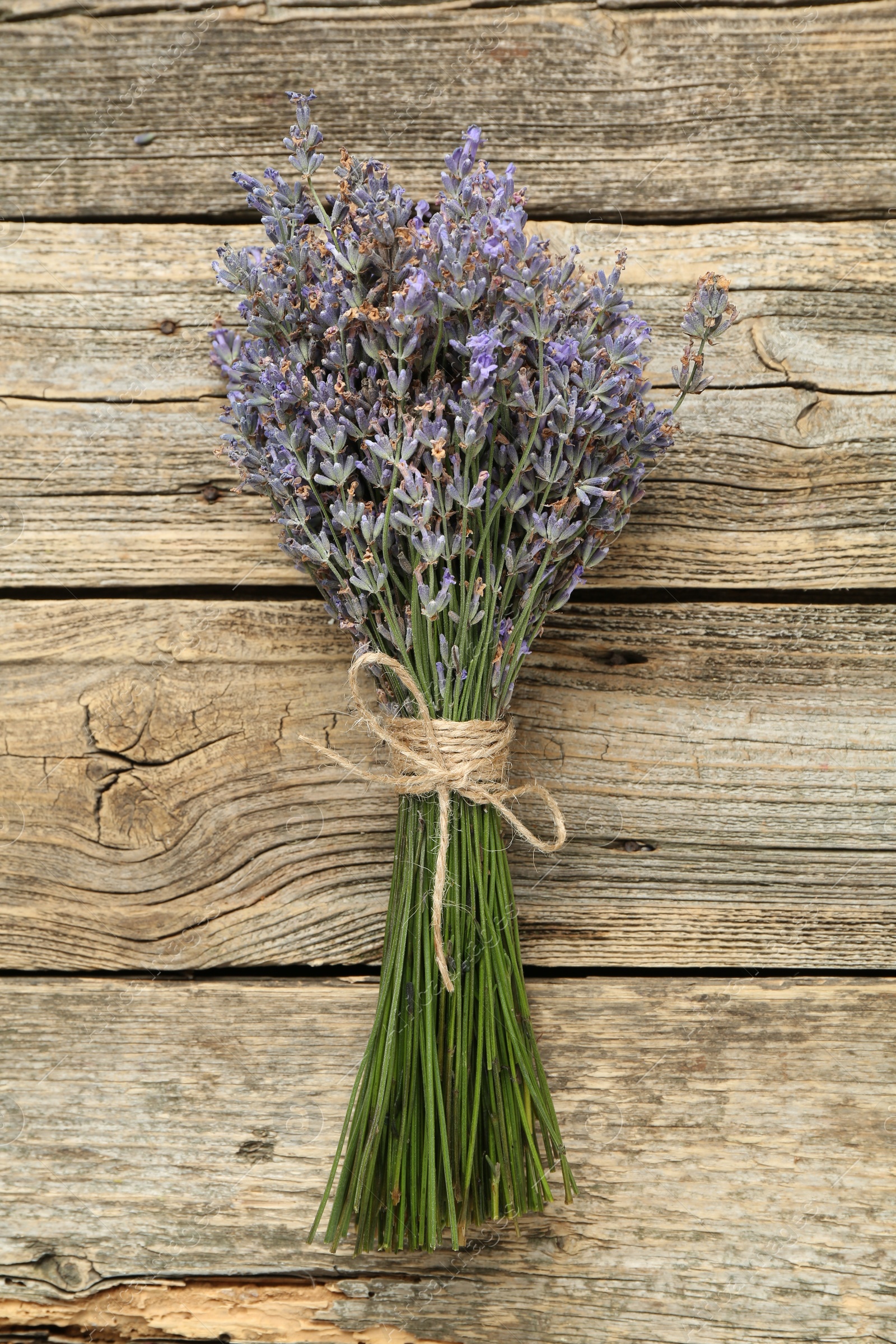 Bunch of beautiful lavender flowers on wooden table, top view Photo of Bunch of beautiful lavender flowers on wooden table, top view