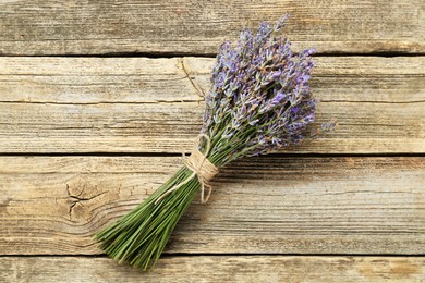 Photo of Bunch of beautiful lavender flowers on wooden table, top view
