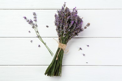 Photo of Bunch of beautiful lavender flowers on white wooden table, flat lay
