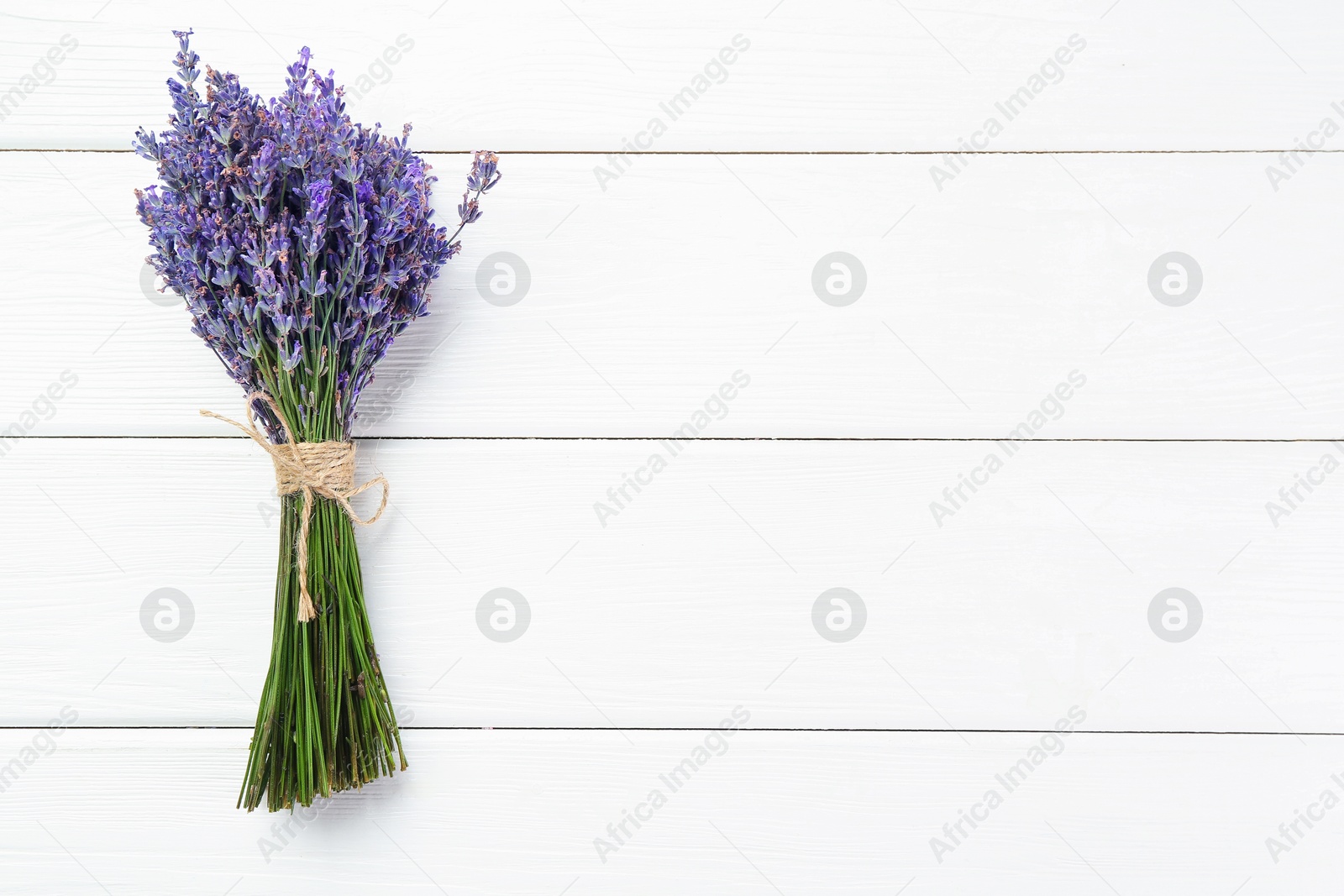 Bunch of beautiful lavender flowers on white wooden table, top view. Space for text Photo of Bunch of beautiful lavender flowers on white wooden table, top view. Space for text