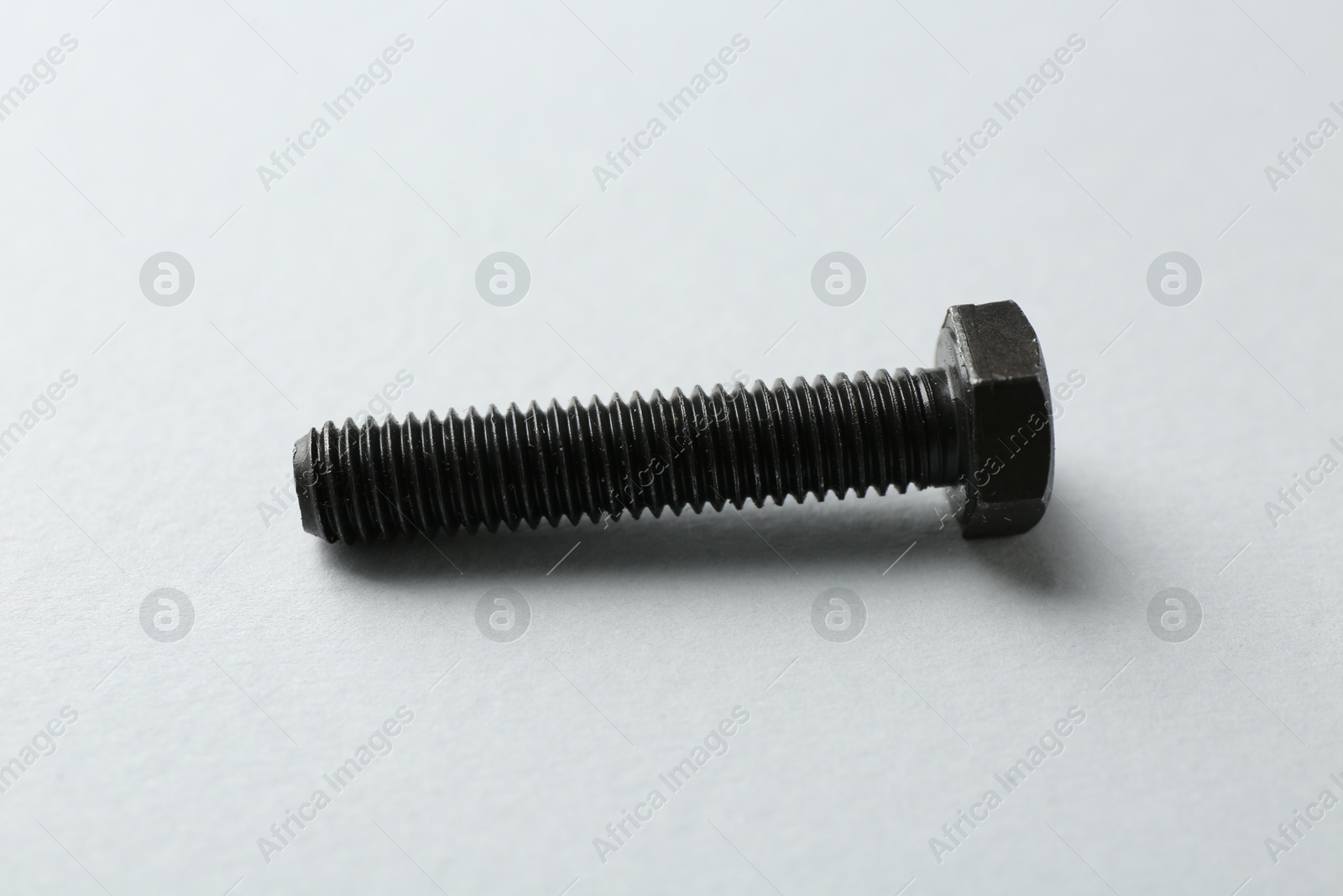 Photo of One metal bolt on white background. Hardware tool