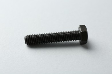 Photo of One metal bolt on white background. Hardware tool