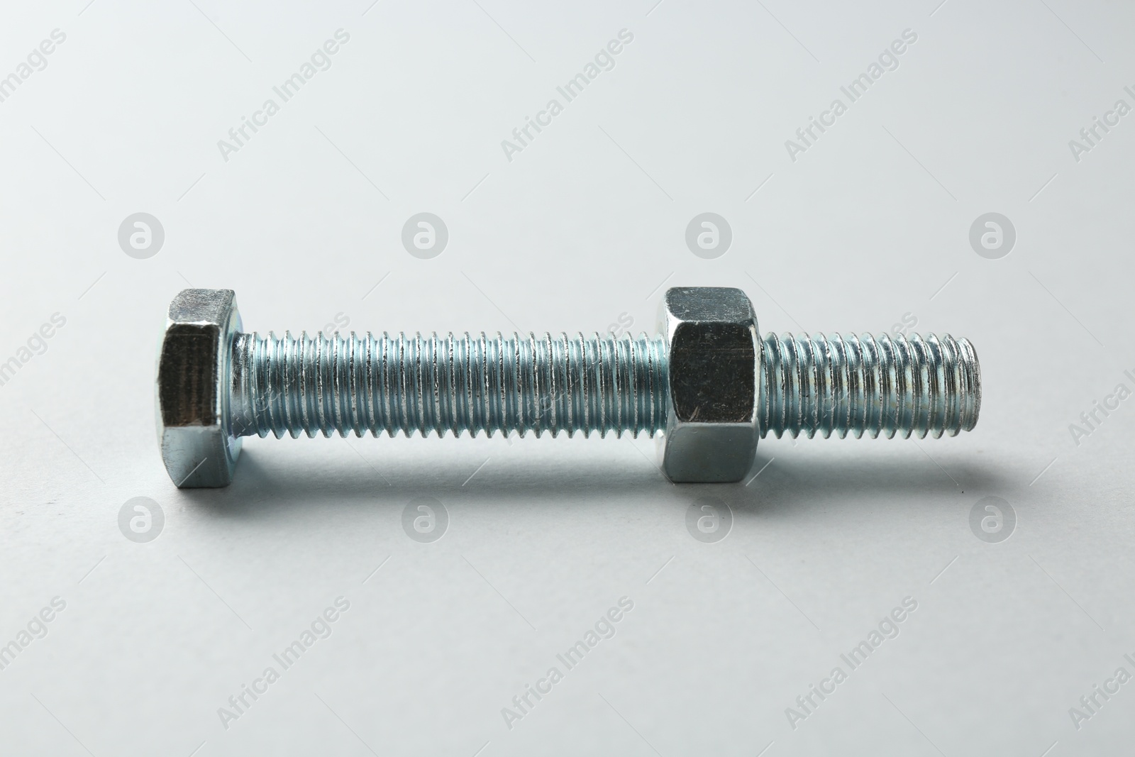 Metal bolt and nut on white background. Hardware tool Photo of Metal bolt and nut on white background. Hardware tool