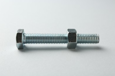 Photo of Metal bolt and nut on white background. Hardware tool