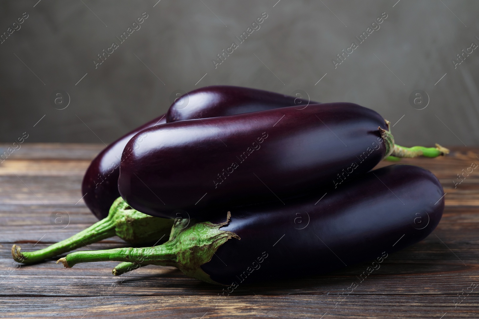 Many ripe eggplants on wooden table, closeup Photo of Many ripe eggplants on wooden table, closeup