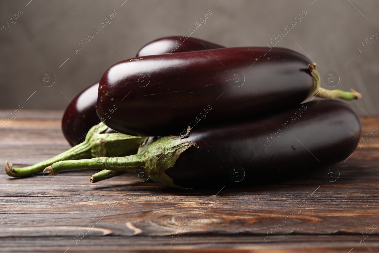 Many ripe eggplants on wooden table, closeup Photo of Many ripe eggplants on wooden table, closeup