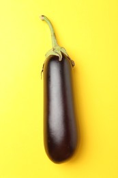 Photo of Ripe eggplant on yellow background, top view