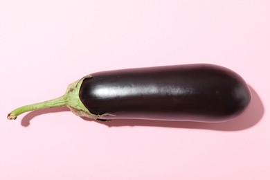 Photo of Ripe eggplant on light pink background, top view