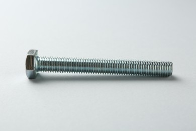 Photo of One metal bolt on white background. Hardware tool