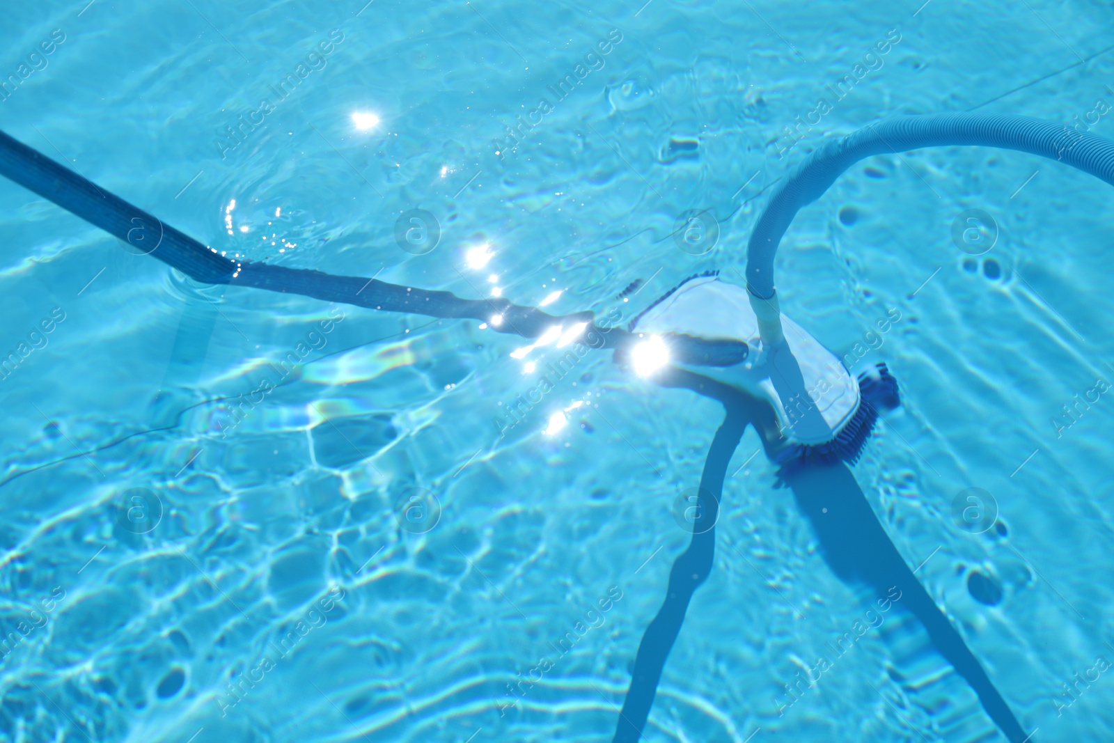 Cleaning outdoor pool with underwater vacuum, closeup Photo of Cleaning outdoor pool with underwater vacuum, closeup