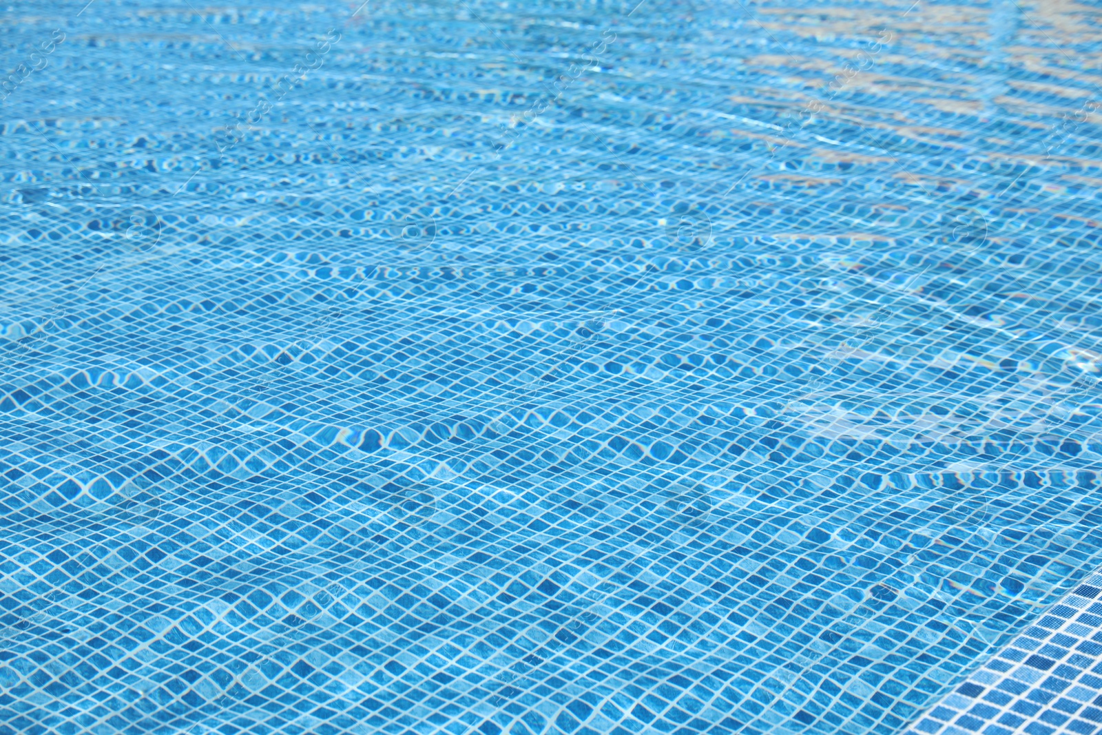 Swimming pool with clean blue water as background. Summer vacation Photo of Swimming pool with clean blue water as background. Summer vacation