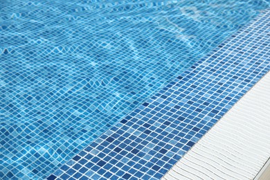 Photo of Outdoor swimming pool with clear water on sunny day. Summer vacation