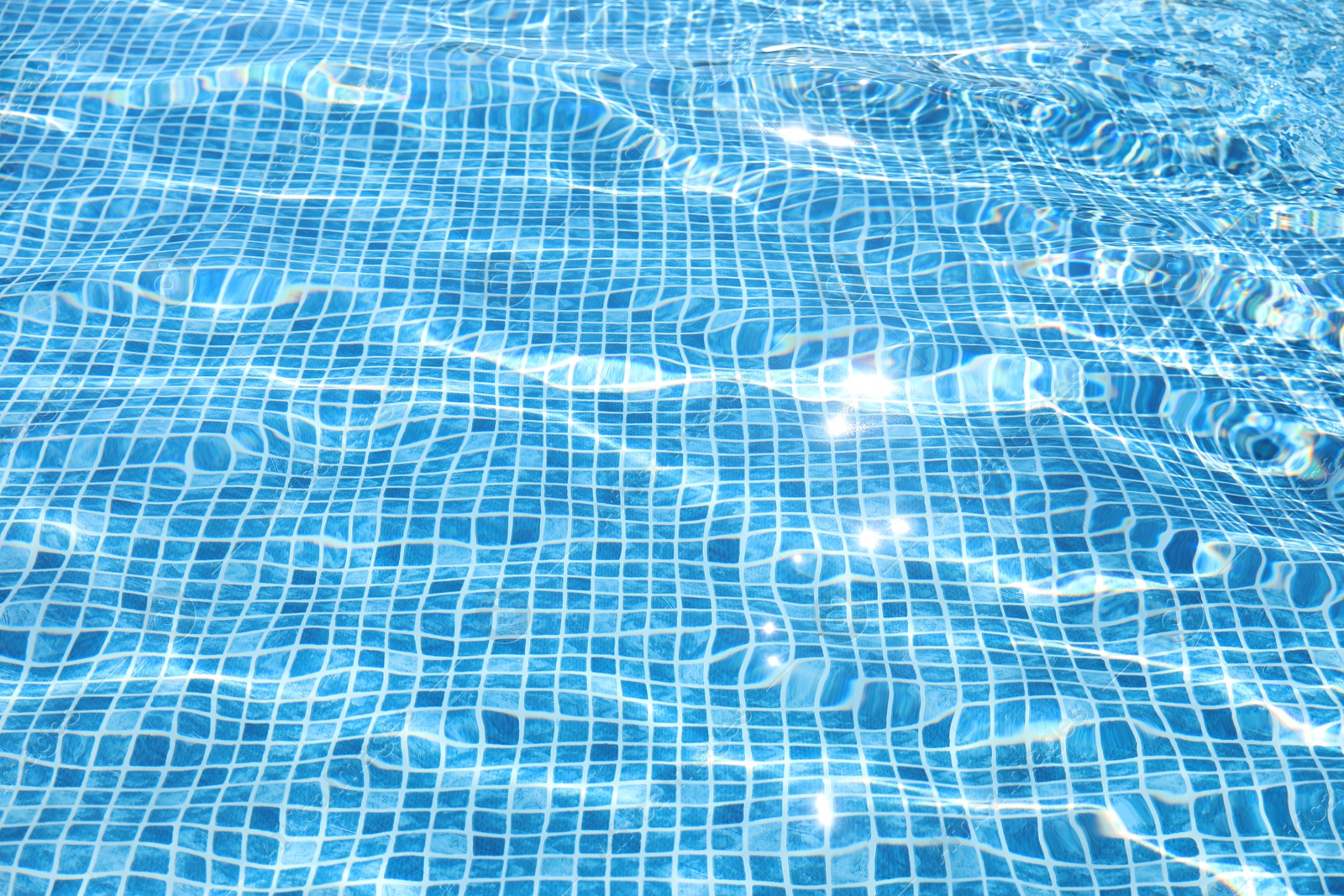 Swimming pool with clean blue water as background. Summer vacation Photo of Swimming pool with clean blue water as background. Summer vacation