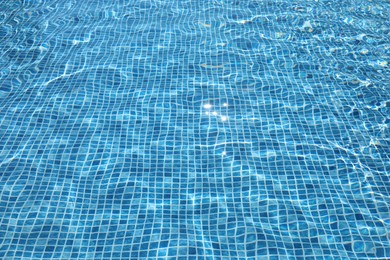 Photo of Swimming pool with clean blue water as background. Summer vacation