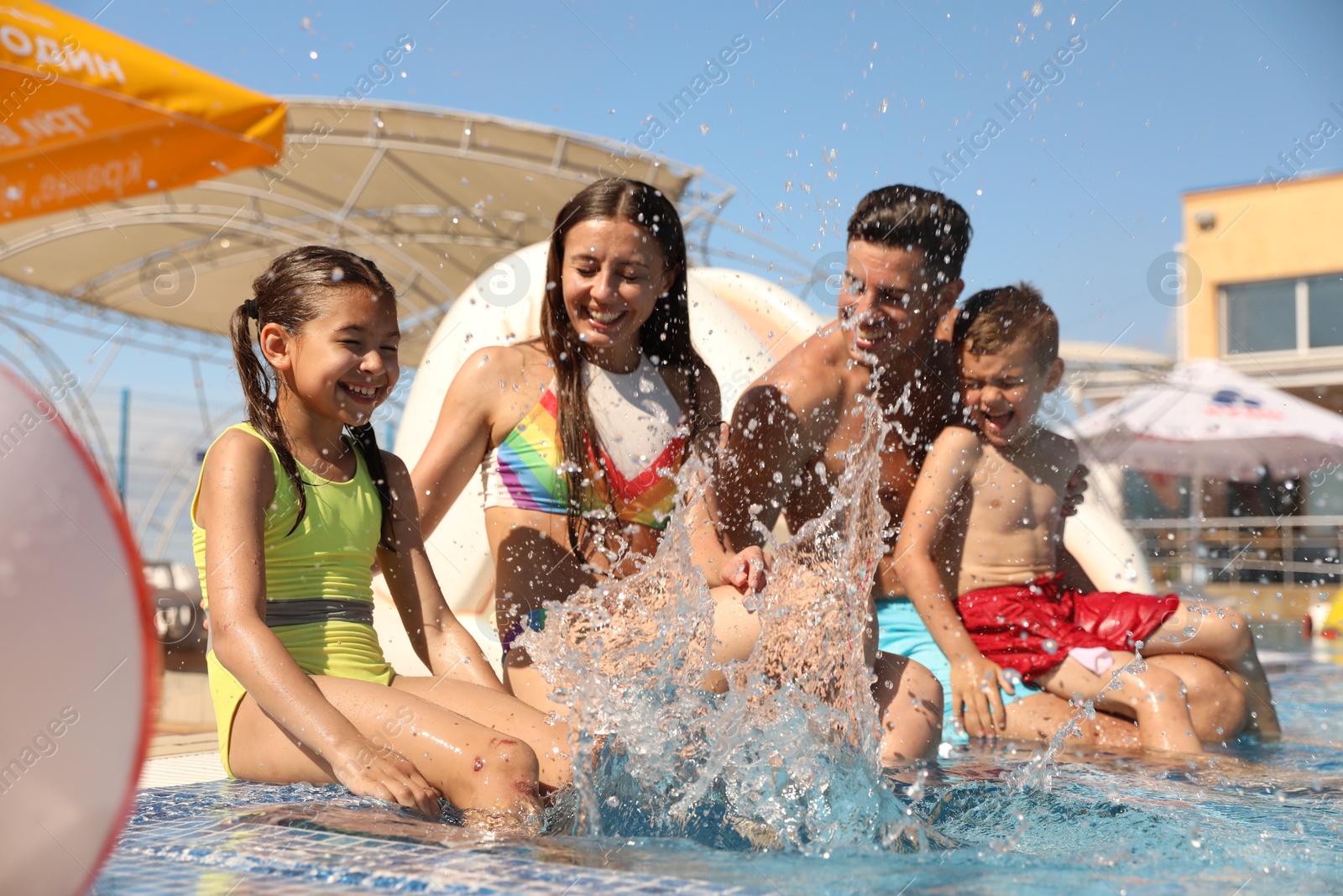 Happy family having fun at water park. Summer vacation Photo of Happy family having fun at water park. Summer vacation