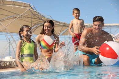 Photo of Happy family having fun at water park. Summer vacation