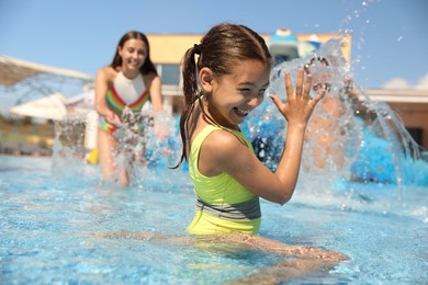 Photo of Happy family having fun at water park. Summer vacation