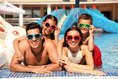 Photo of Happy family in swimming pool. Summer vacation