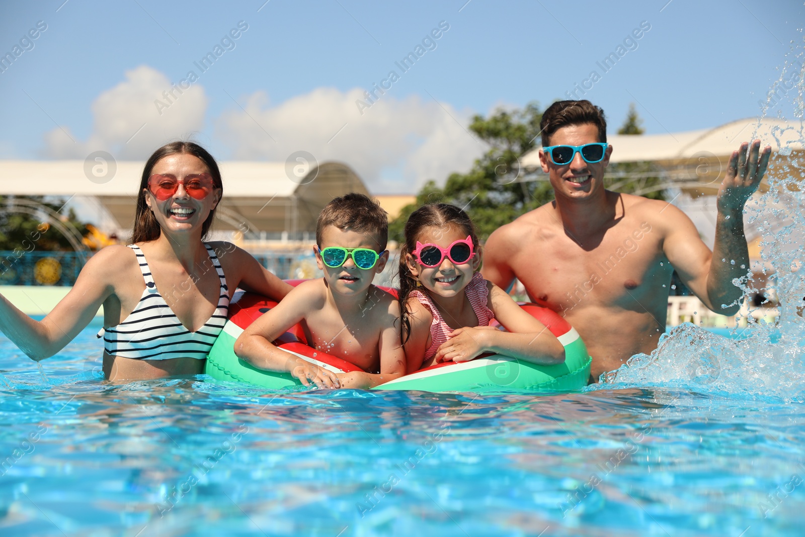 Happy family in swimming pool. Summer vacation Photo of Happy family in swimming pool. Summer vacation