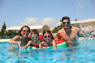 Photo of Happy family in swimming pool. Summer vacation