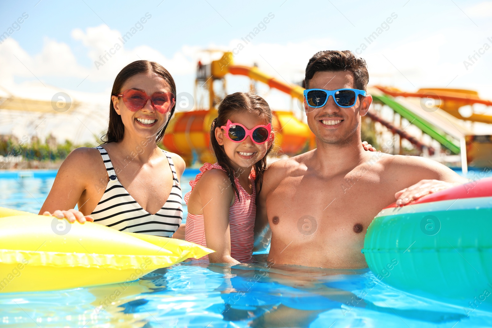 Happy family in swimming pool. Summer vacation Photo of Happy family in swimming pool. Summer vacation