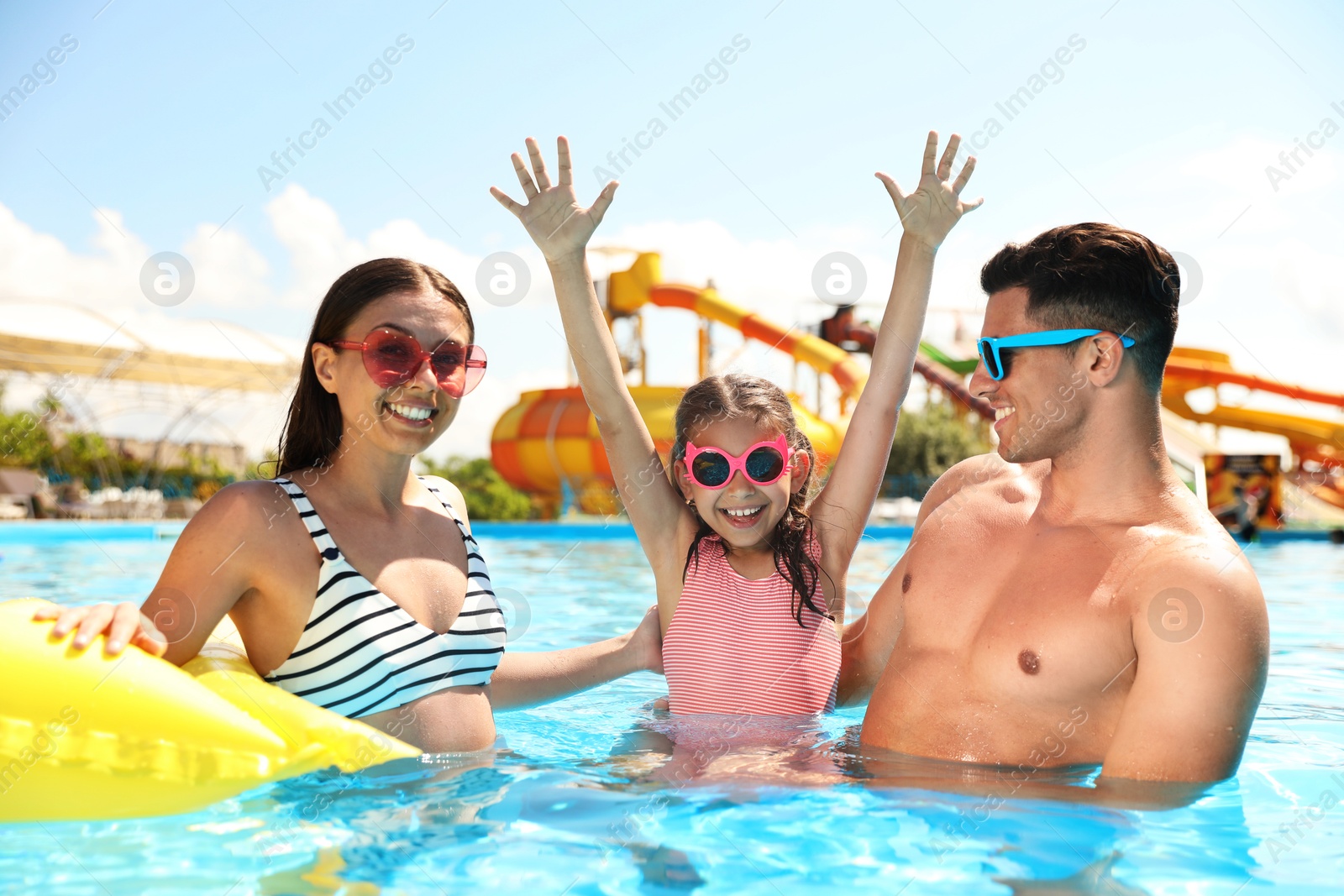 Happy family in swimming pool. Summer vacation Photo of Happy family in swimming pool. Summer vacation