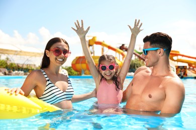 Photo of Happy family in swimming pool. Summer vacation
