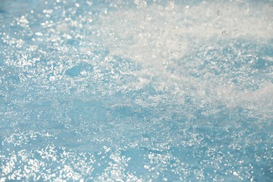 Photo of Splashes in swimming pool on sunny day. Summer vacation