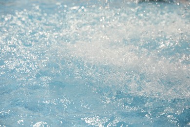 Photo of Splashes in swimming pool on sunny day. Summer vacation