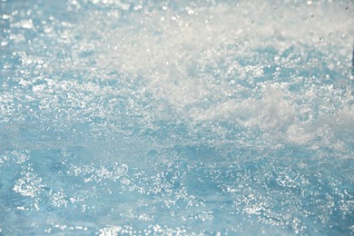 Photo of Splashes in swimming pool on sunny day. Summer vacation