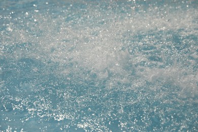 Photo of Splashes in swimming pool on sunny day. Summer vacation