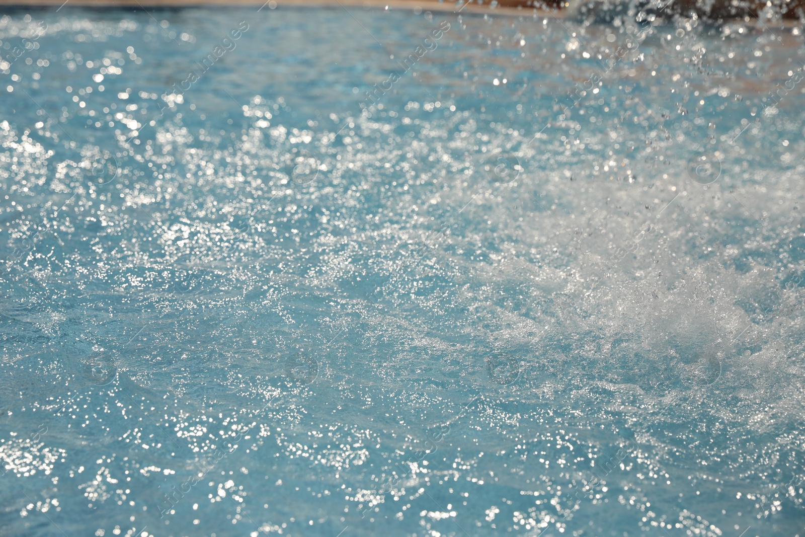 Splashes in swimming pool on sunny day. Summer vacation Photo of Splashes in swimming pool on sunny day. Summer vacation