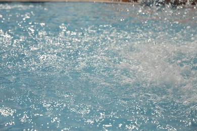 Photo of Splashes in swimming pool on sunny day. Summer vacation
