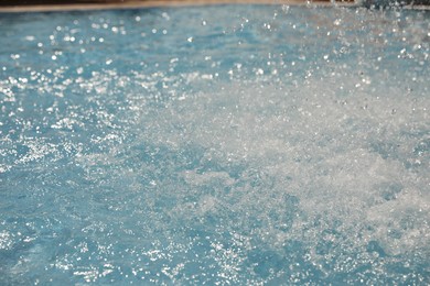 Photo of Splashes in swimming pool on sunny day. Summer vacation
