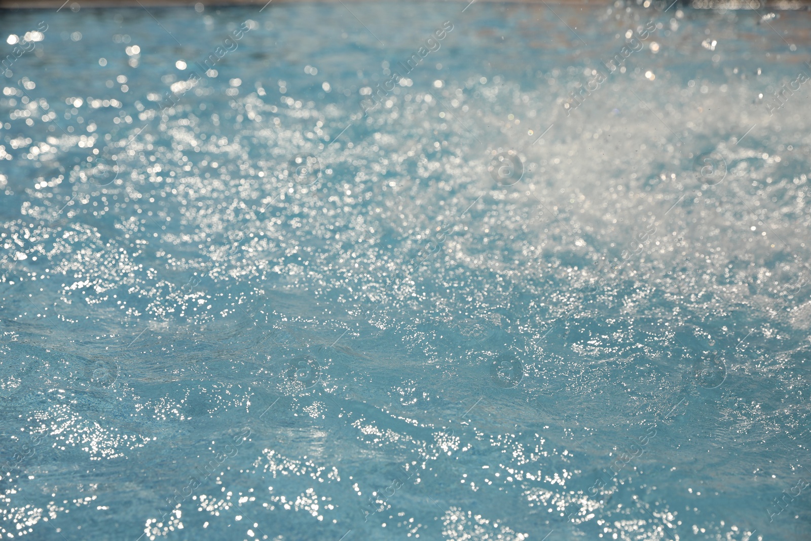 Splashes in swimming pool on sunny day. Summer vacation Photo of Splashes in swimming pool on sunny day. Summer vacation